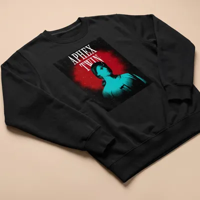 Retro graphic tee featuring a bold portrait of Aphex Twin with colorful text. — printed on a unisex sweatshirt