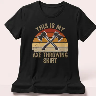Retro distressed t-shirt featuring crossed hatchets and the text 'This Is My Axe Throwing Shirt' — printed on a women's shirt