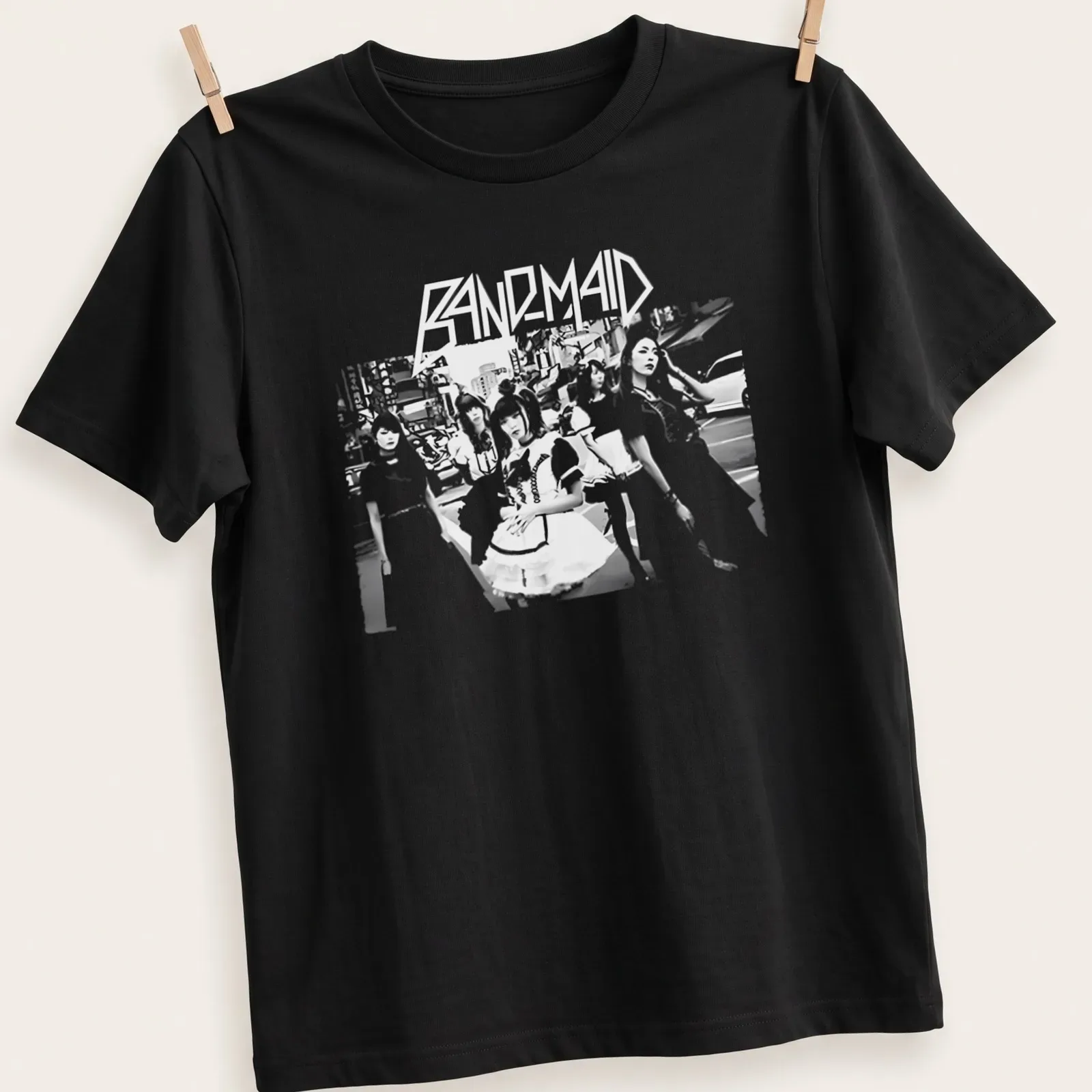 Monochrome silhouette t-shirt featuring the text Band Maid in an urban scene. — printed on a unisex t-shirt