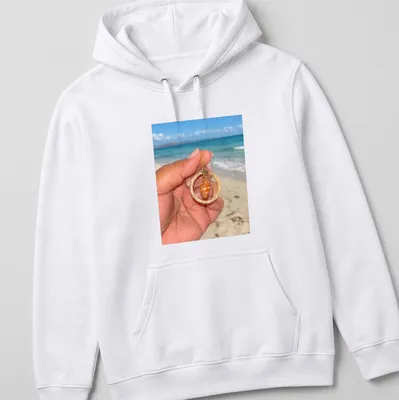 Orange shell jewelry in beach photography style with woven hoops — printed on a unisex hoodie