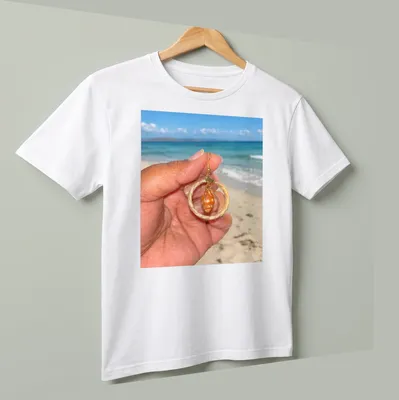 Orange shell jewelry in beach photography style with woven hoops — printed on a unisex t-shirt (angled view)