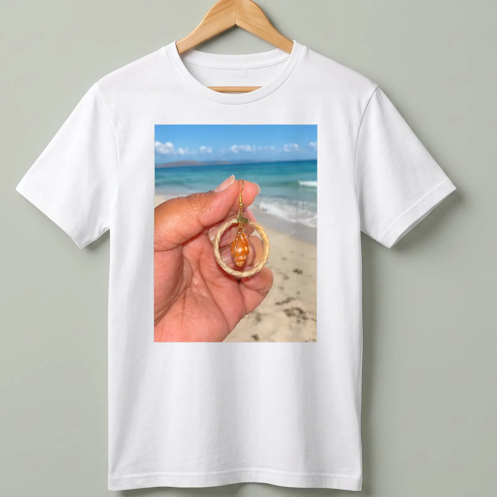 Orange shell jewelry in beach photography style with woven hoops — printed on a unisex t-shirt