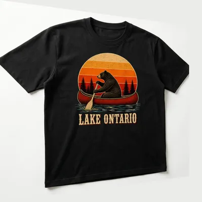 Vintage illustration of a bear canoeing with Lake Ontario text in warm colors — printed on a unisex t-shirt (angled view)
