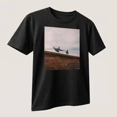 Photographic design of birds perched on a brick wall in natural colors — printed on a unisex t-shirt (angled view)