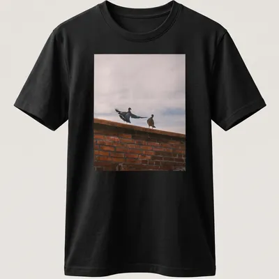 Photographic design of birds perched on a brick wall in natural colors — printed on a unisex t-shirt