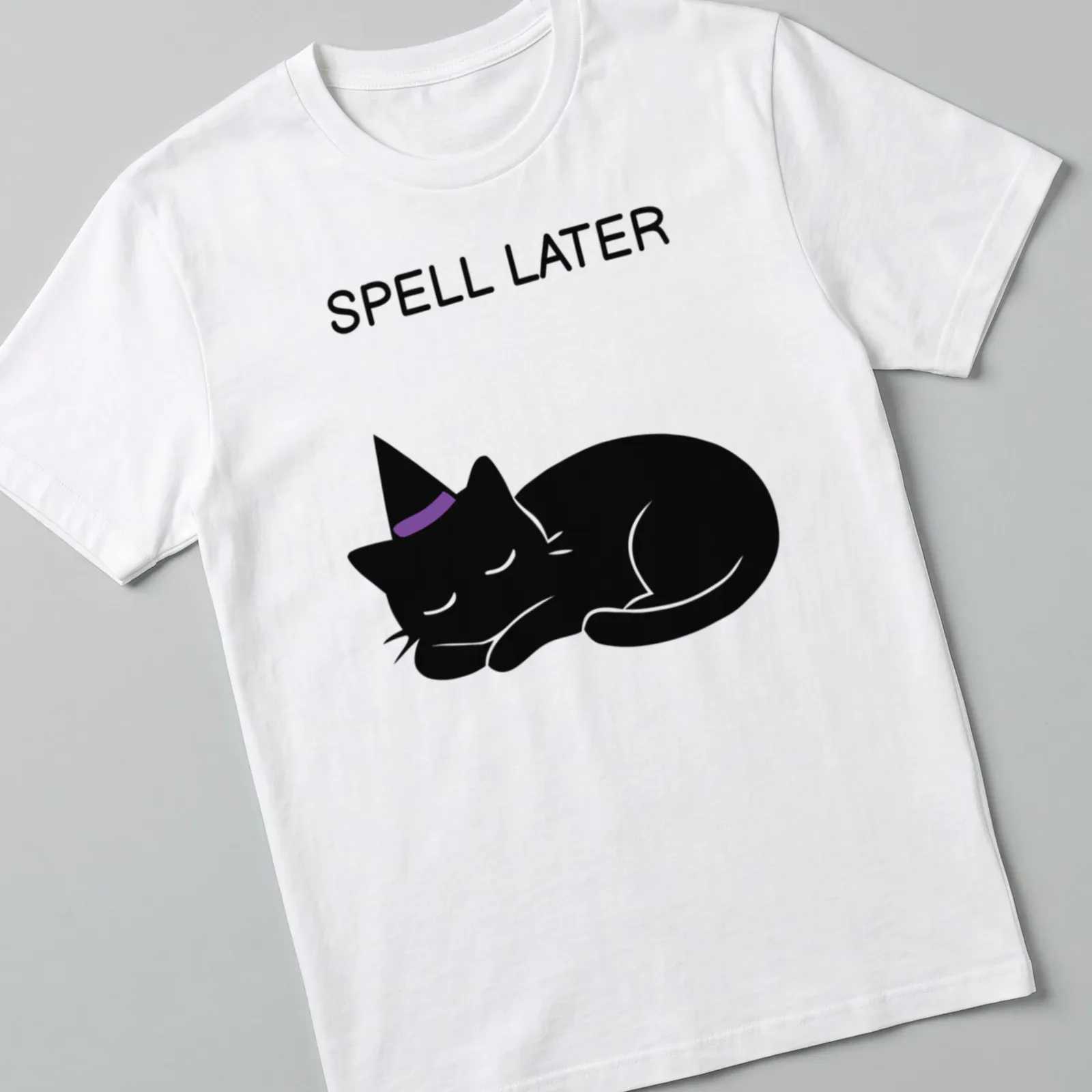 Cartoon of a sleeping black cat with the text 'Spell Later' in purple — printed on a unisex t-shirt