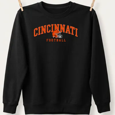 Retro Cincinnati football helmet design in orange, black, and white with bold lettering. — printed on a unisex sweatshirt
