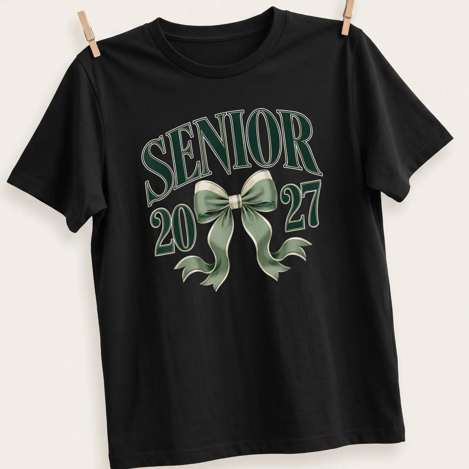 Elegant T-shirt featuring a coquette bow and graduation year in green and white — printed on a unisex t-shirt