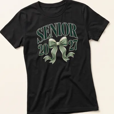 Elegant T-shirt featuring a coquette bow and graduation year in green and white — printed on a women's shirt