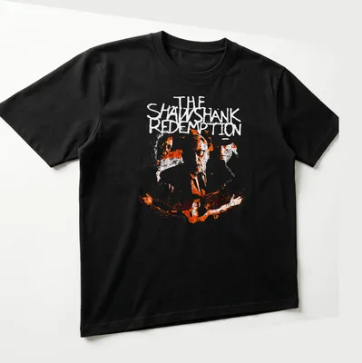 Boxy silhouette design featuring crime drama faces and the words THE SATANIC in white on orange — printed on a unisex t-shirt (angled view)