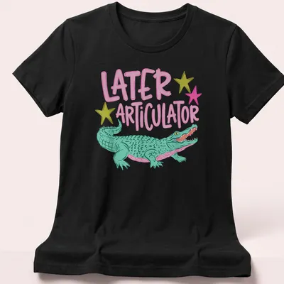 Cartoon crocodile with text 'Later Articulator' in bright colors — printed on a women's shirt