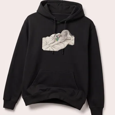 Realistic print of a cute cat stretching towards a colorful feather toy — printed on a unisex hoodie