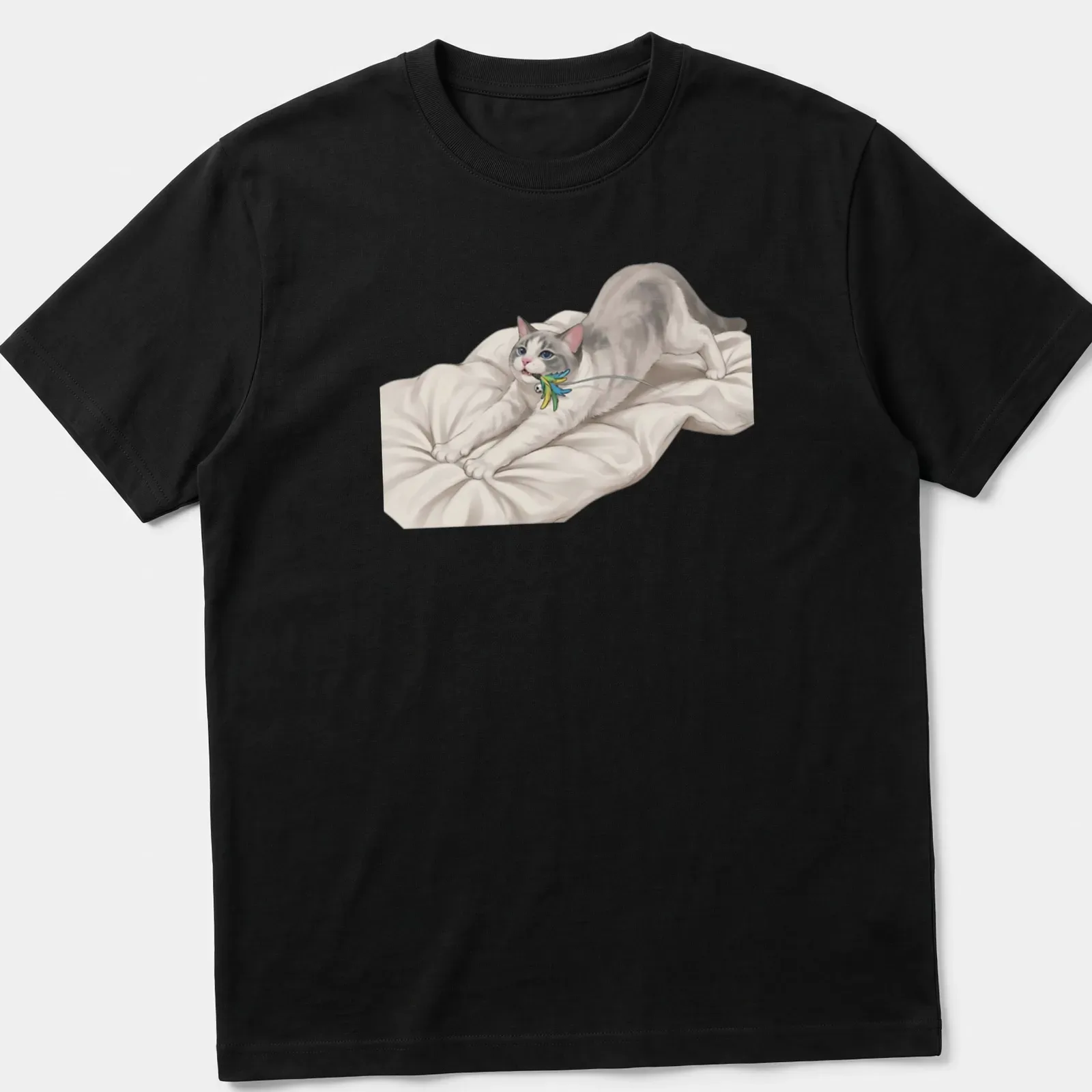 Realistic print of a cute cat stretching towards a colorful feather toy — printed on a unisex t-shirt