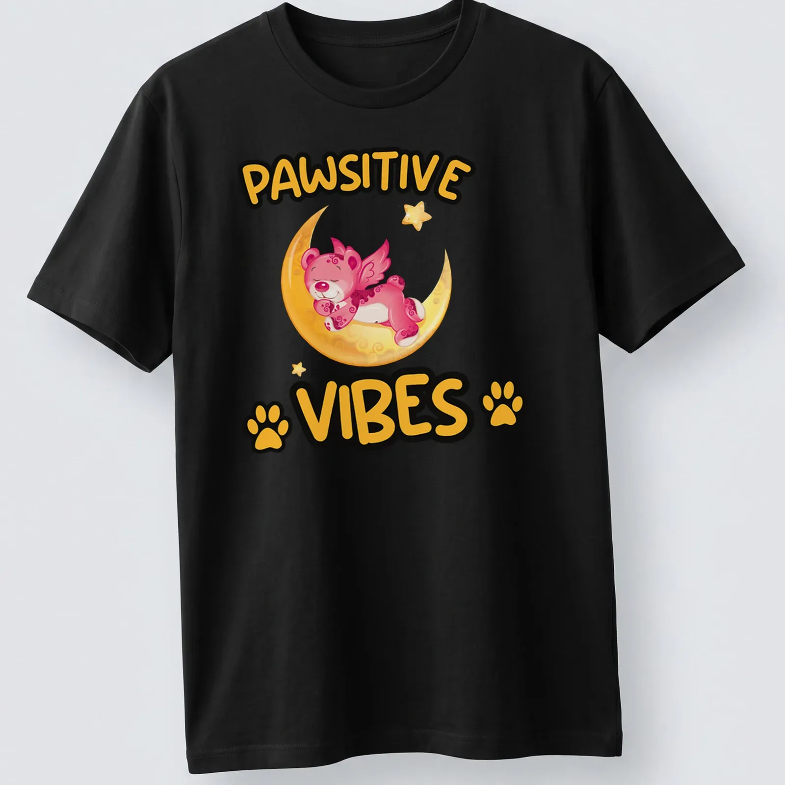 Kawaii design of a magical bear on a moon with the text Pawsitive Vibes — printed on a unisex t-shirt