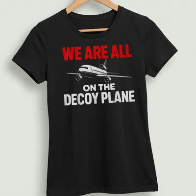 Bold distressed decoy plane t-shirt with humorous quote in red, white, and gray — printed on a women's shirt