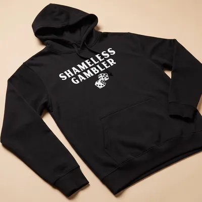 Black and white illustration of dice with the text Shameless Gambler — printed on a unisex hoodie