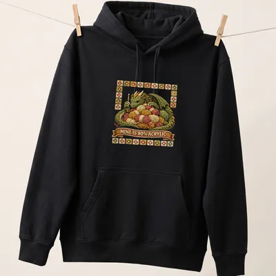 Illustration of a mischievous dragon tangled in colorful yarn with embroidered texture — printed on a unisex hoodie