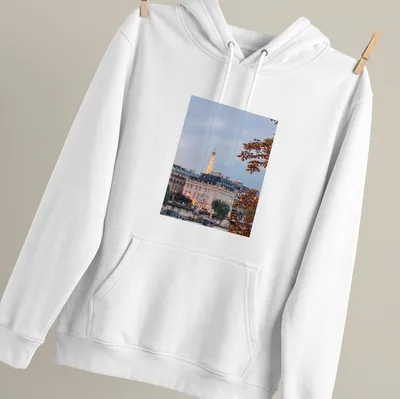 Photographic print of the Eiffel Tower with a Paris cityscape in gray, gold, green, and brown — printed on a unisex hoodie