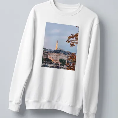 Photographic print of the Eiffel Tower with a Paris cityscape in gray, gold, green, and brown — printed on a unisex sweatshirt