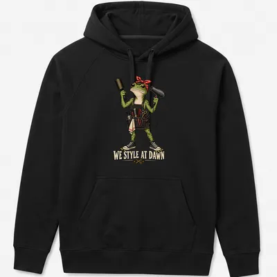 Colorful cartoon frog hair stylist with tools and humorous text — printed on a unisex hoodie