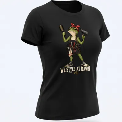 Colorful cartoon frog hair stylist with tools and humorous text — printed on a women's shirt