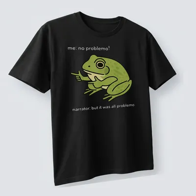 Cartoon frog meme t-shirt with the text 'me, no problemo!' underneath — printed on a unisex t-shirt (angled view)