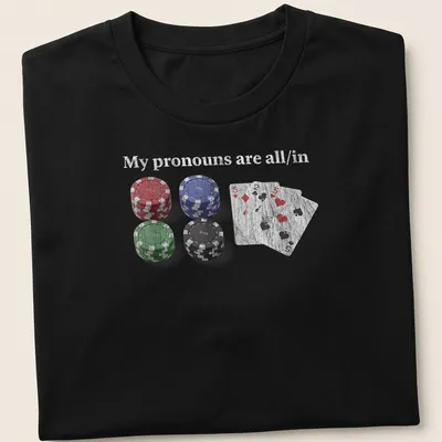 Distressed t-shirt featuring poker chips and cards with the text 'My pronouns are all/in.'