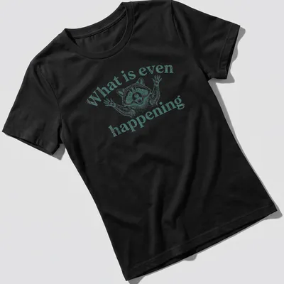 Vintage illustration of a puzzled raccoon with text 'What is even happening' — printed on a women's shirt