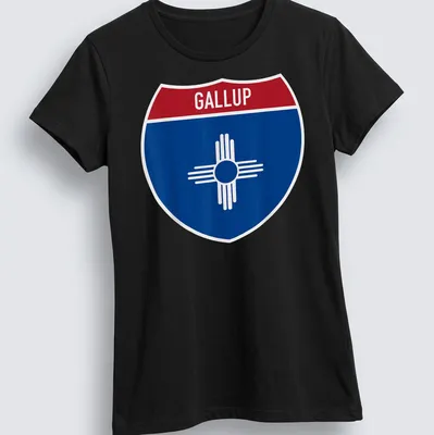 Bold graphic of Gallup highway sign in blue, red, and white — printed on a women's shirt