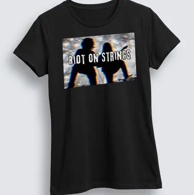 Grunge style T-shirt with silhouettes of guitar players and the text Riot On Strings — printed on a women's shirt