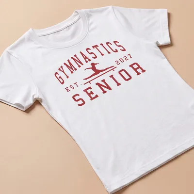 Bold collegiate Gymnastics Senior 2027 t-shirt with a gymnast graphic — printed on a women's shirt