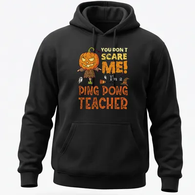 Cartoon pumpkin character with humorous text 'You Don't Scare Me! Ping Dong Teacher' in orange and black — printed on a unisex hoodie