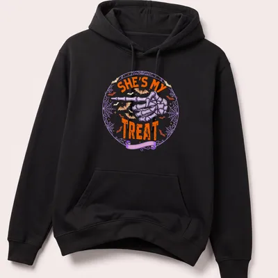 Playful Halloween t-shirt with skeleton hand and text She's My Treat — printed on a unisex hoodie