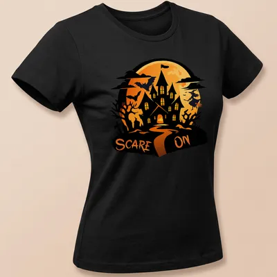 Cartoon haunted house t-shirt with the text 'SCARE ON' above in orange and black — printed on a women's shirt