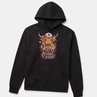 Playful cartoon of a Highland cow with colors brown, pink, and green, alongside text about coffee and chaos. — printed on a unisex hoodie