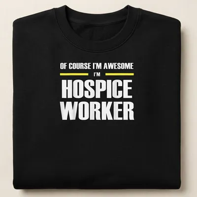 Bold typography shirt reading 'Of Course I’m Awesome I’m Hospice Worker' in black, yellow, and white — printed on a unisex sweatshirt