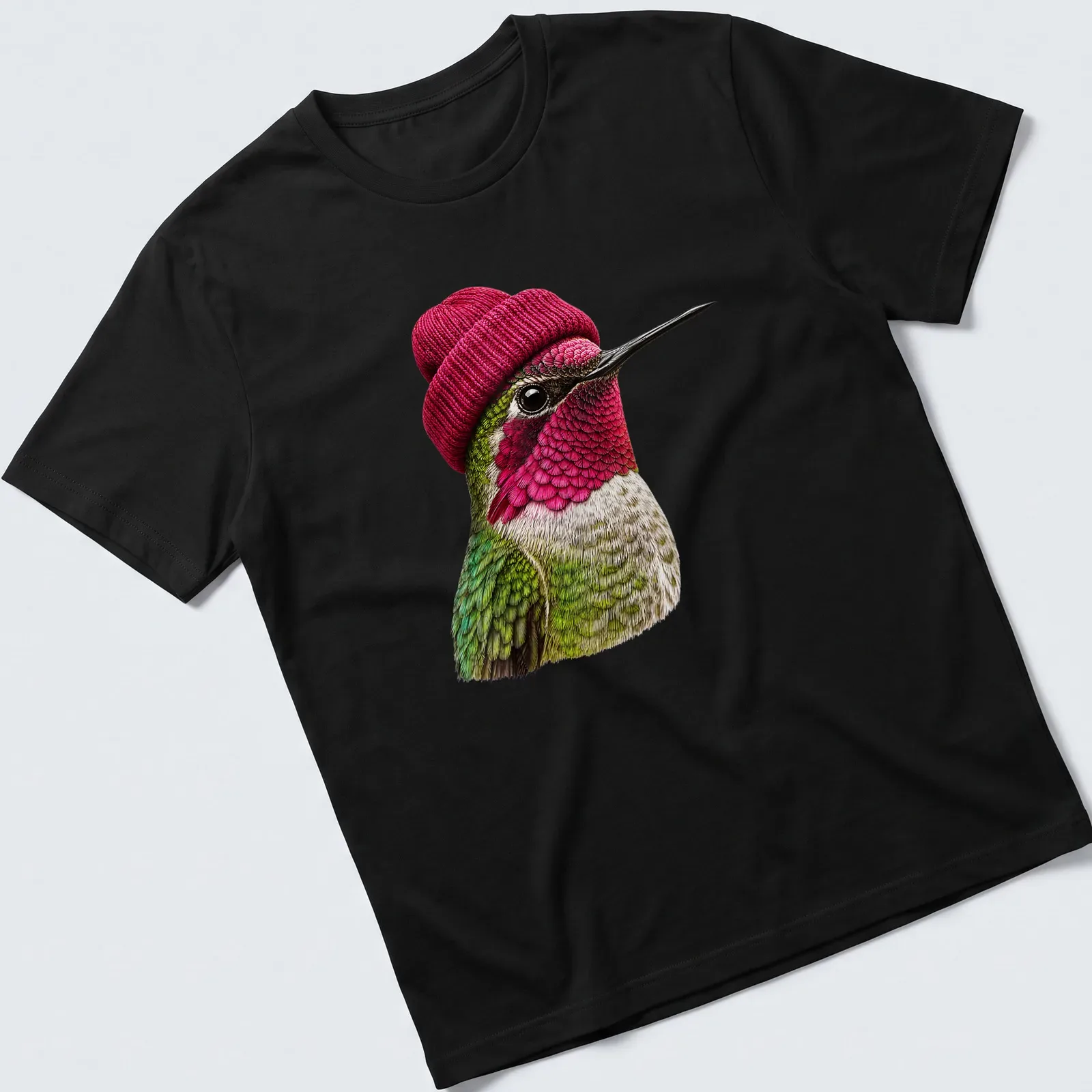 Realistic hummingbird wearing a beanie in green, pink, and white — printed on a unisex t-shirt