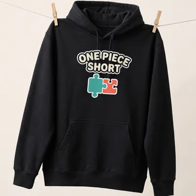 Playful illustration of a jigsaw puzzle piece with text One Piece Short — printed on a unisex hoodie