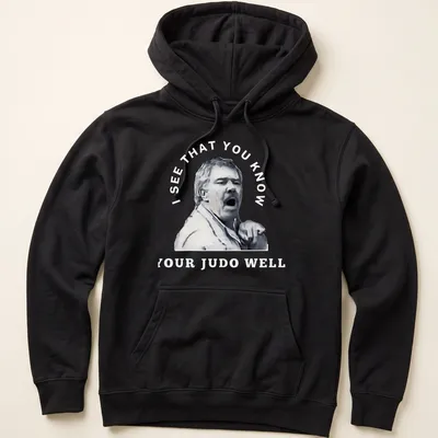 Stylized portrait of a passionate judo coach with motivational text — printed on a unisex hoodie