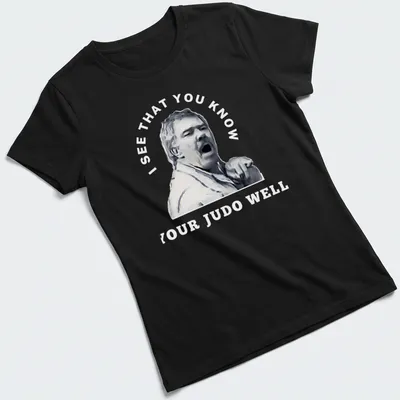 Stylized portrait of a passionate judo coach with motivational text — printed on a women's shirt