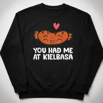 Kawaii t-shirt featuring a smiling kielbasa with playful text above. — printed on a unisex sweatshirt