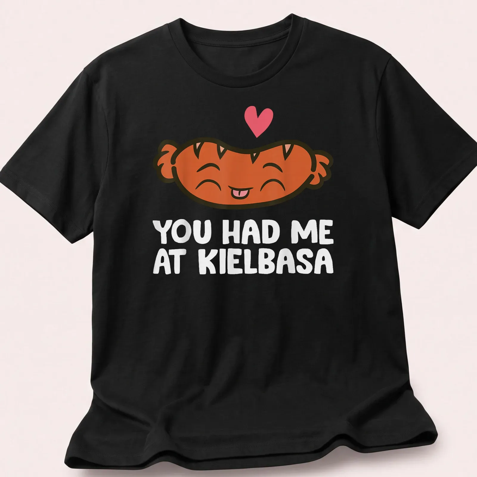 Kawaii t-shirt featuring a smiling kielbasa with playful text above. — printed on a unisex t-shirt