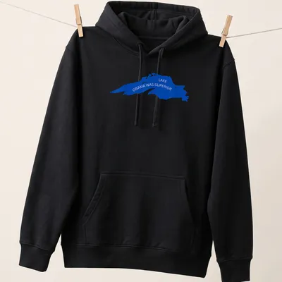 Silhouette of a lake with the text Lake Obama Was Superior in blue — printed on a unisex hoodie