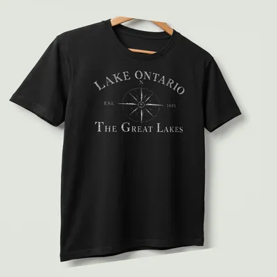 Vintage compass design featuring Lake Ontario history in black and white. — printed on a unisex t-shirt (angled view)