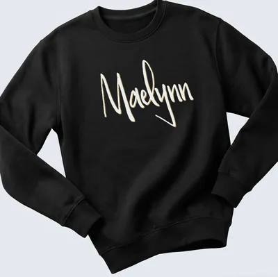 Personalized T-shirt with the name Maelynn in elegant gold script on white — printed on a unisex sweatshirt