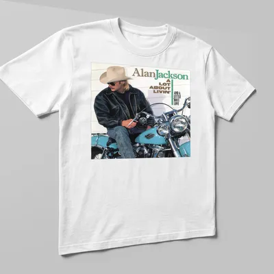 Vintage Alan Jackson tee featuring a motorcycle and lyrics in earthy tones — printed on a unisex t-shirt (angled view)