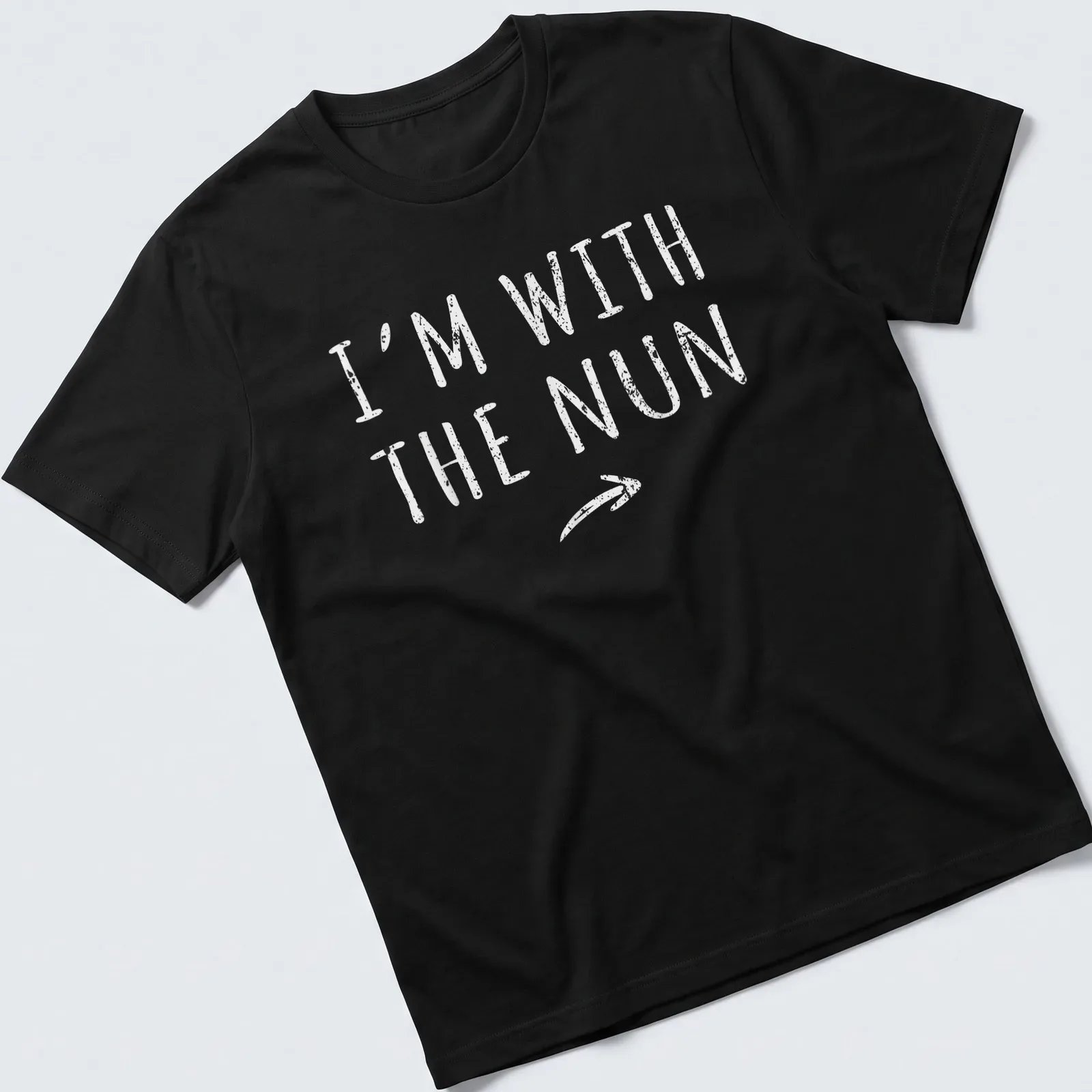 Bold printed text I'm With The Nun on a white t-shirt with a nun graphic — printed on a unisex t-shirt
