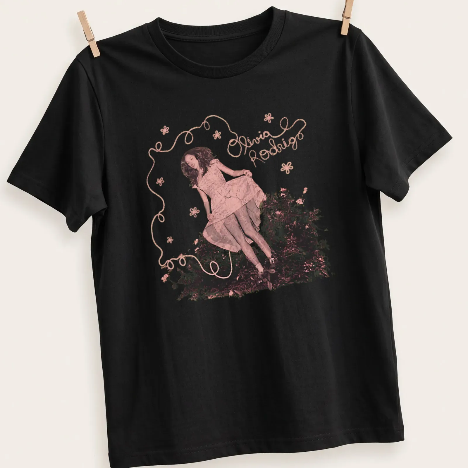 Whimsical floral design featuring Olivia Rodrigo's name in pink and green — printed on a unisex t-shirt