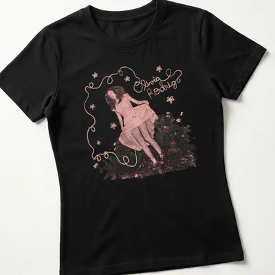 Whimsical floral design featuring Olivia Rodrigo's name in pink and green — printed on a women's shirt