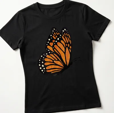 Watercolor print of an orange butterfly with intricate wings on a — printed on a women's shirt